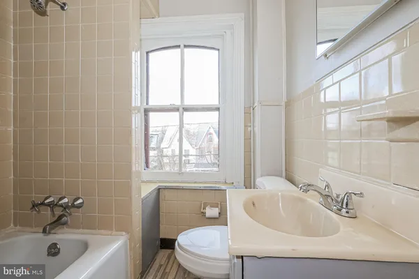 a bathroom with a sink a toilet and bathtub