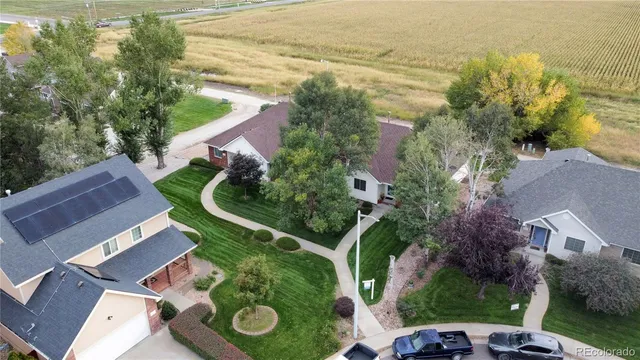 an aerial view of a house with garden space and ocean view