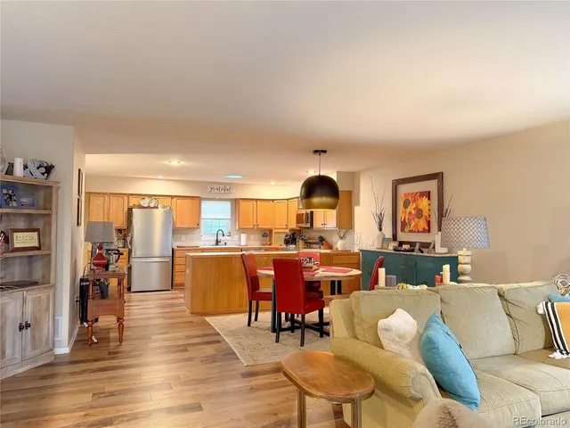 a living room with furniture wooden floor and a rug