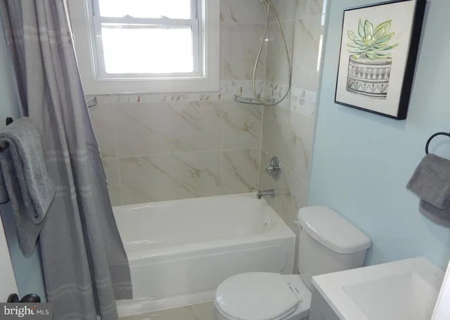 a bathroom with a toilet and a bathtub