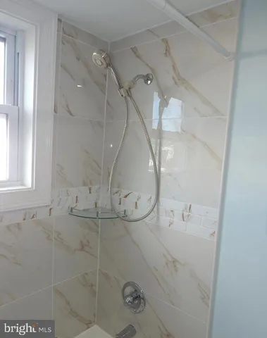 a bathroom with a glass shower door