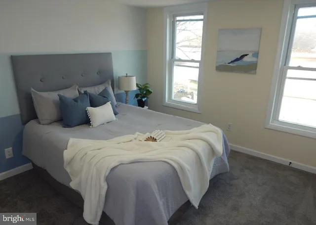 a bedroom with bed and window