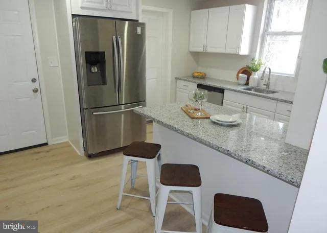 a kitchen with sink and refrigerator