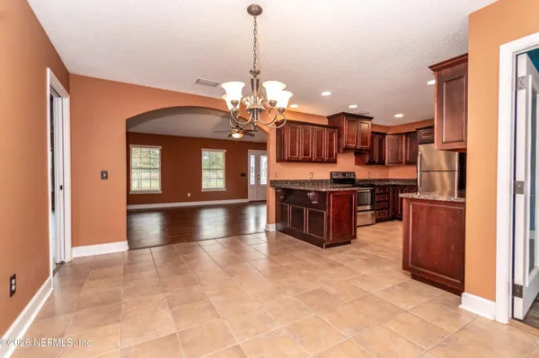 a view of a room with wooden floor and fan