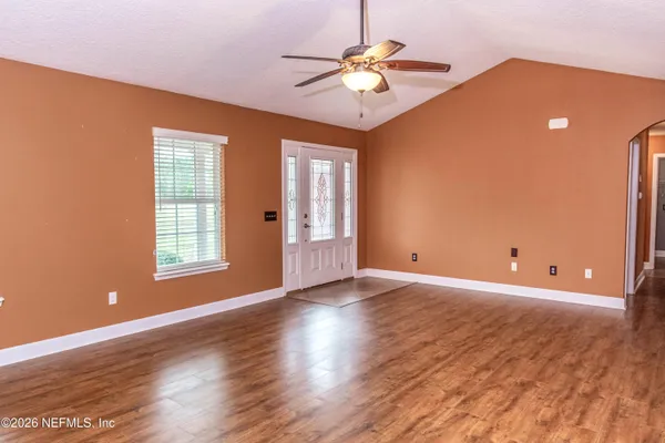 wooden floor in an empty room with a window
