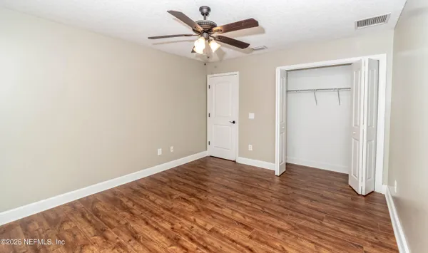 a kitchen with granite countertop white cabinets and refrigerator