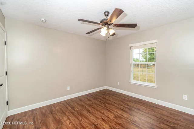 a bathroom with a granite countertop toilet sink and mirror