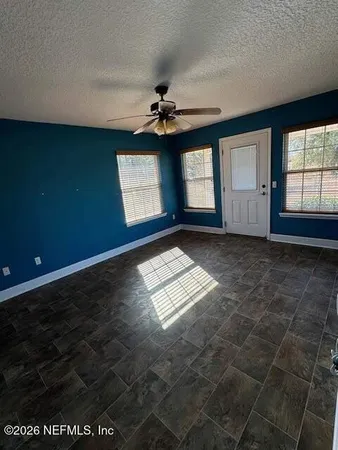 a view of house with backyard and glass windows