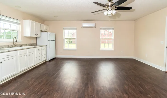 a view of a dry yard with trees