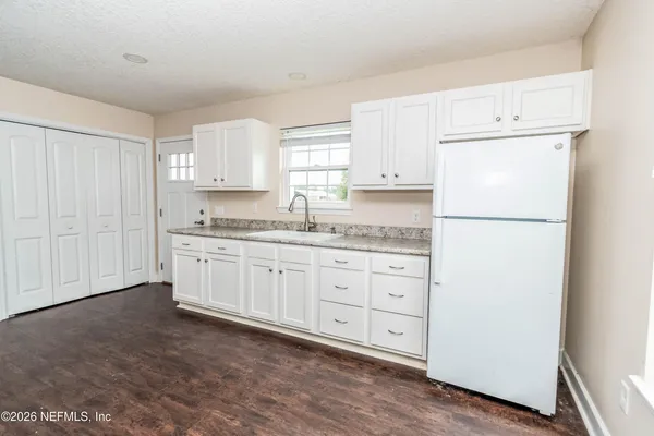an outdoor sitting area with red umbrella