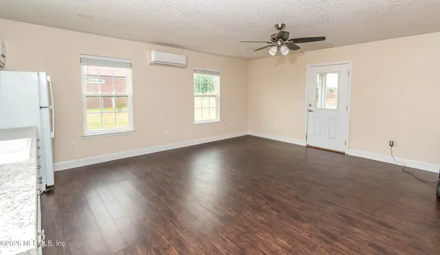 aerial view of a house with a yard and lake view