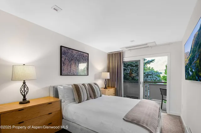 a bathroom with a shower and a glass door