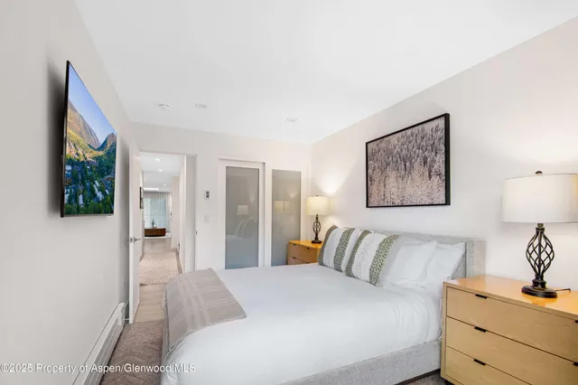 a bedroom with a balcony a bed and a lamp on table