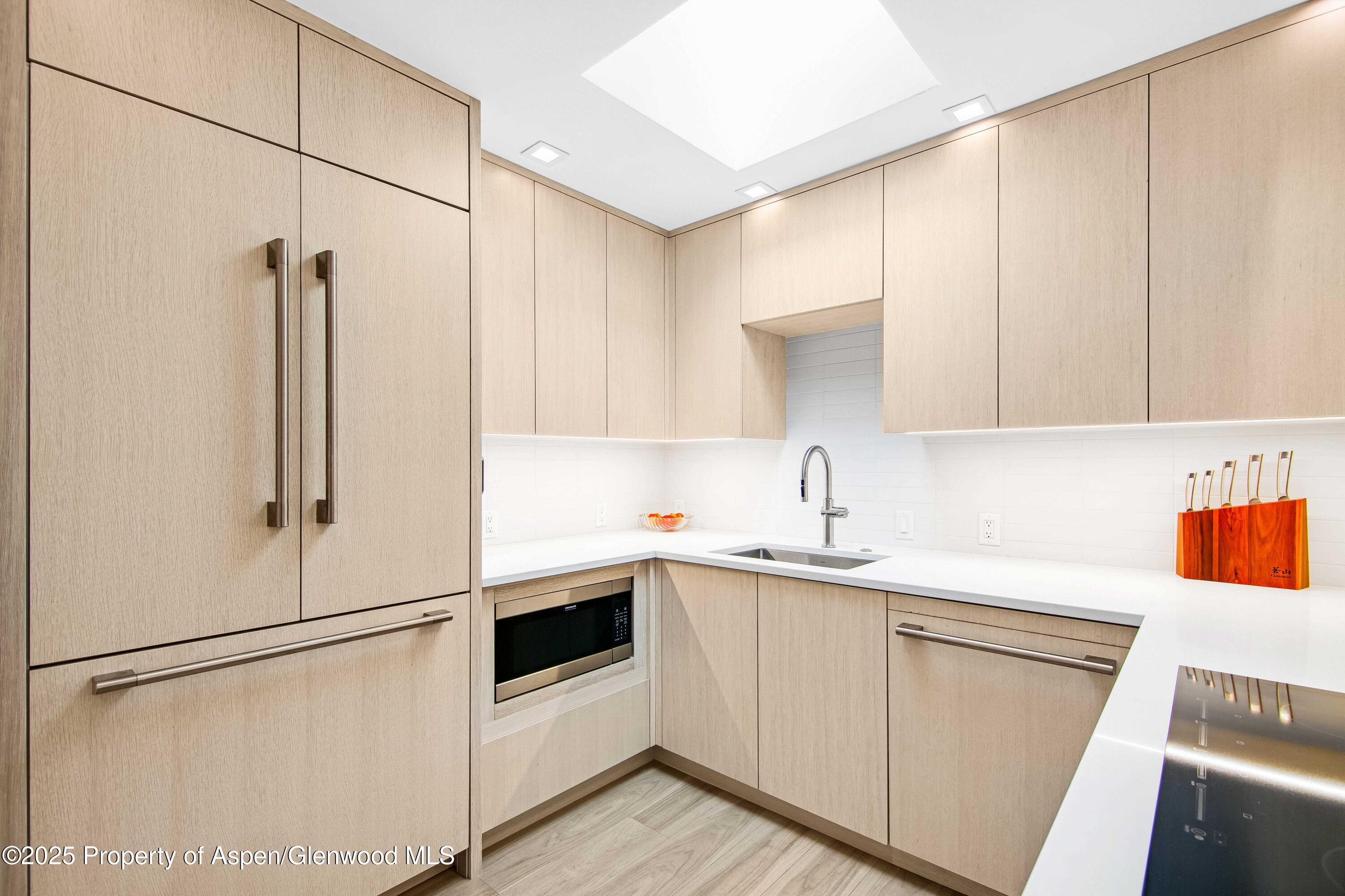 a kitchen with white cabinets and white appliances