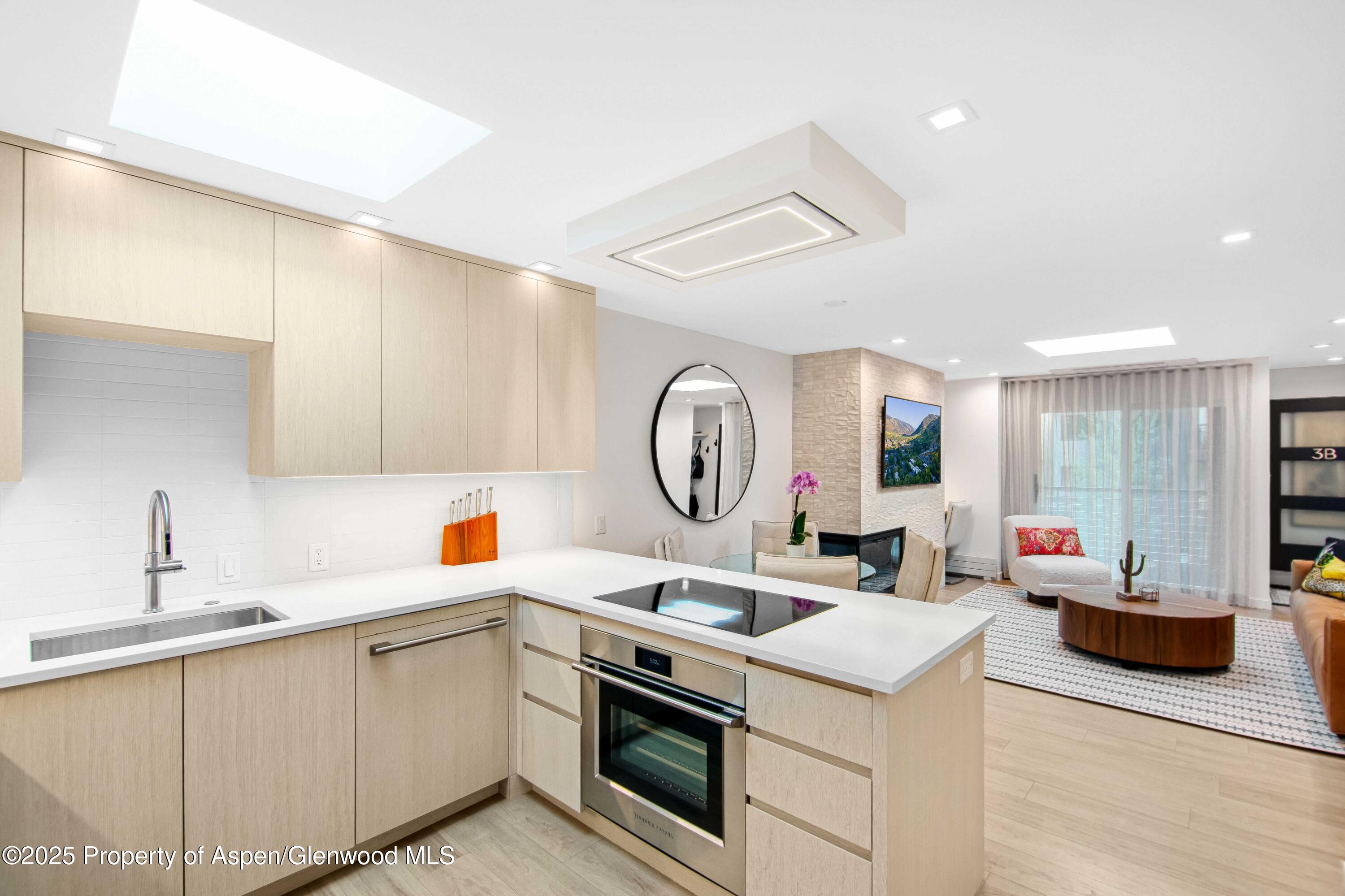 100 East Dean Street, Unit 3B Aspen, CO 81611 - Photo 4 of 16 a kitchen with a sink cabinets and wooden floor