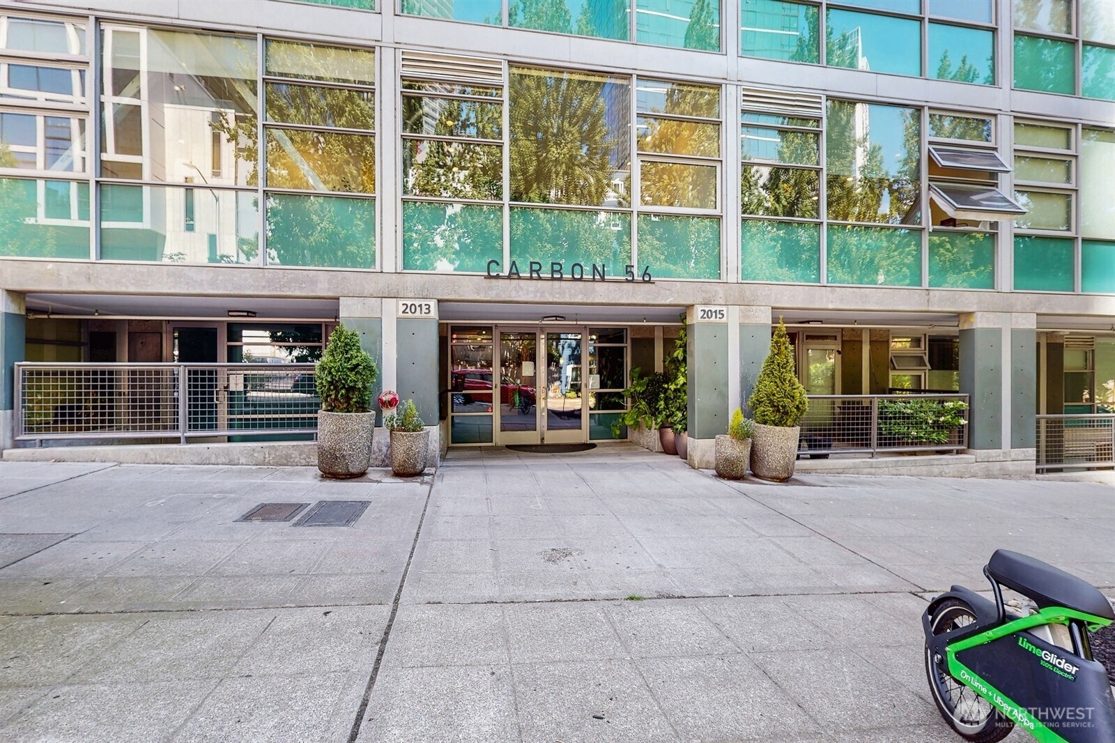 2015 Terry Avenue, Unit 301 Seattle, WA 98121 - Photo 15 of 15 front view of a brick building with a bench and windows