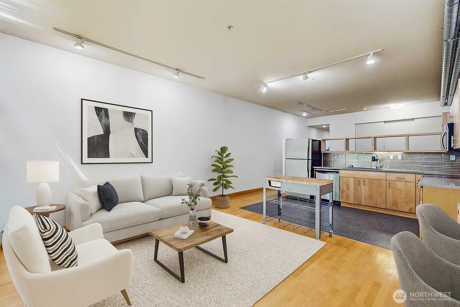 2015 Terry Avenue, Unit 301 Seattle, WA 98121 - Photo 2 of 15 a living room with furniture and kitchen view