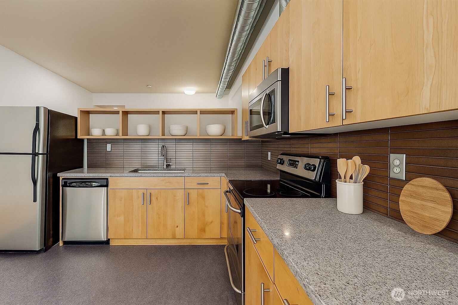 2015 Terry Avenue, Unit 301 Seattle, WA 98121 - Photo 8 of 14 a kitchen with stainless steel appliances granite countertop a sink stove and refrigerator