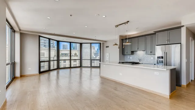 a kitchen with stainless steel appliances a refrigerator and a stove top oven