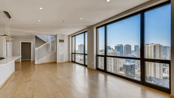 a view of an entryway with wooden floor