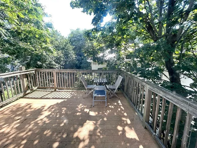 a view of balcony with wooden floor and outdoor seating