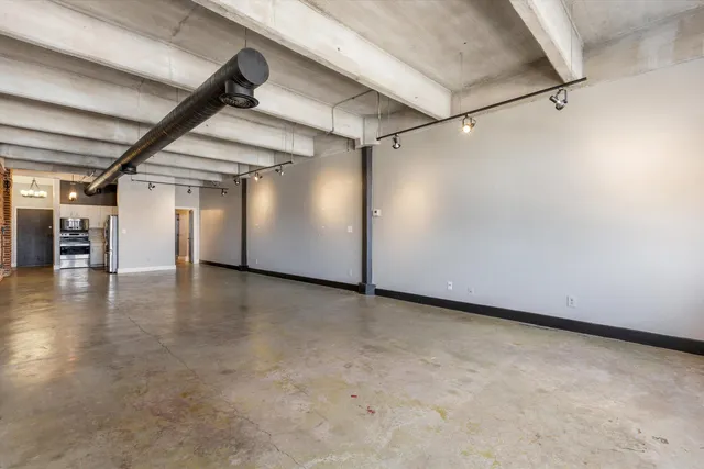 an empty room with furniture and wooden floor