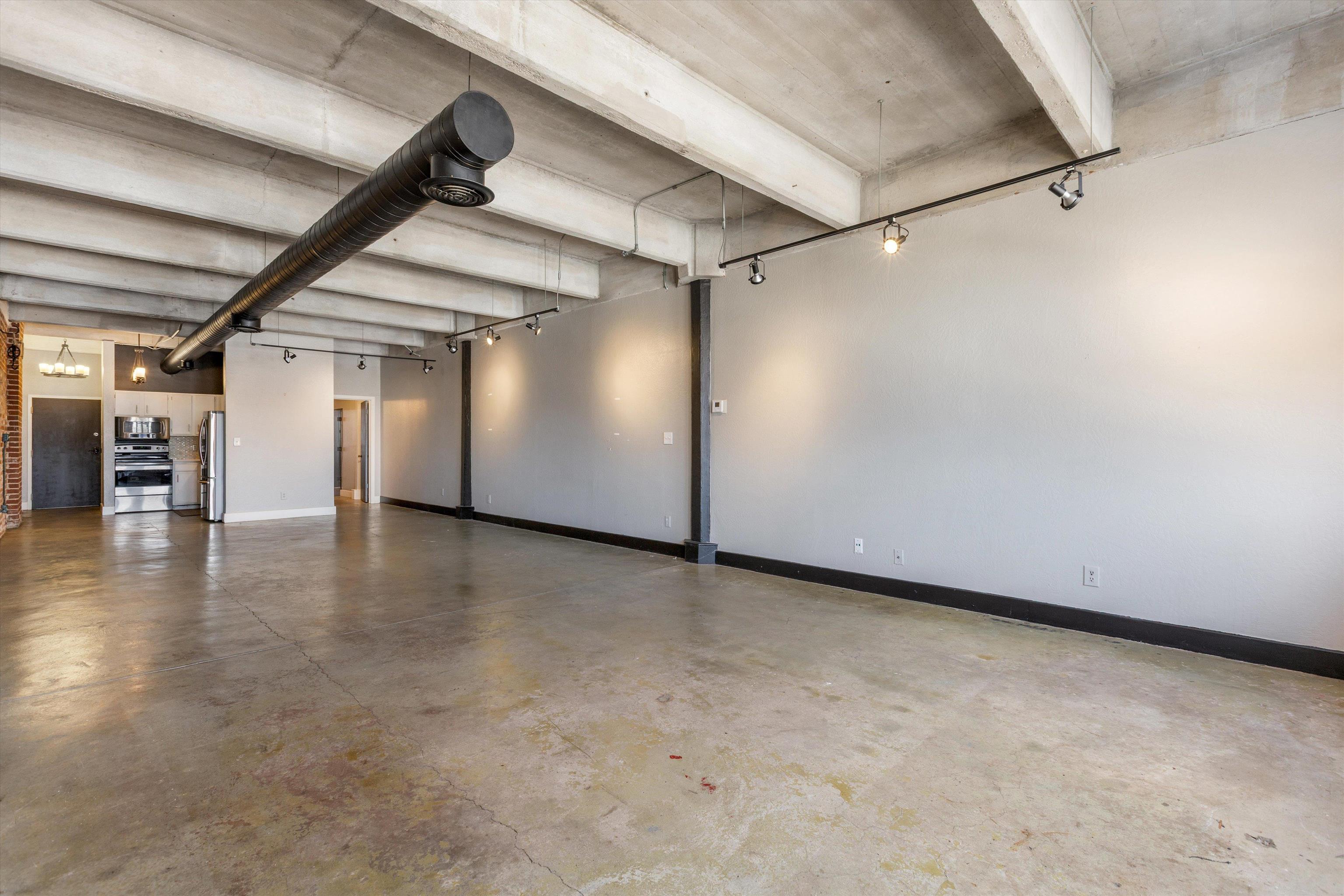 408 South Front Street, Unit 413 Memphis, TN 38103 - Photo 14 of 30 an empty room with furniture and wooden floor