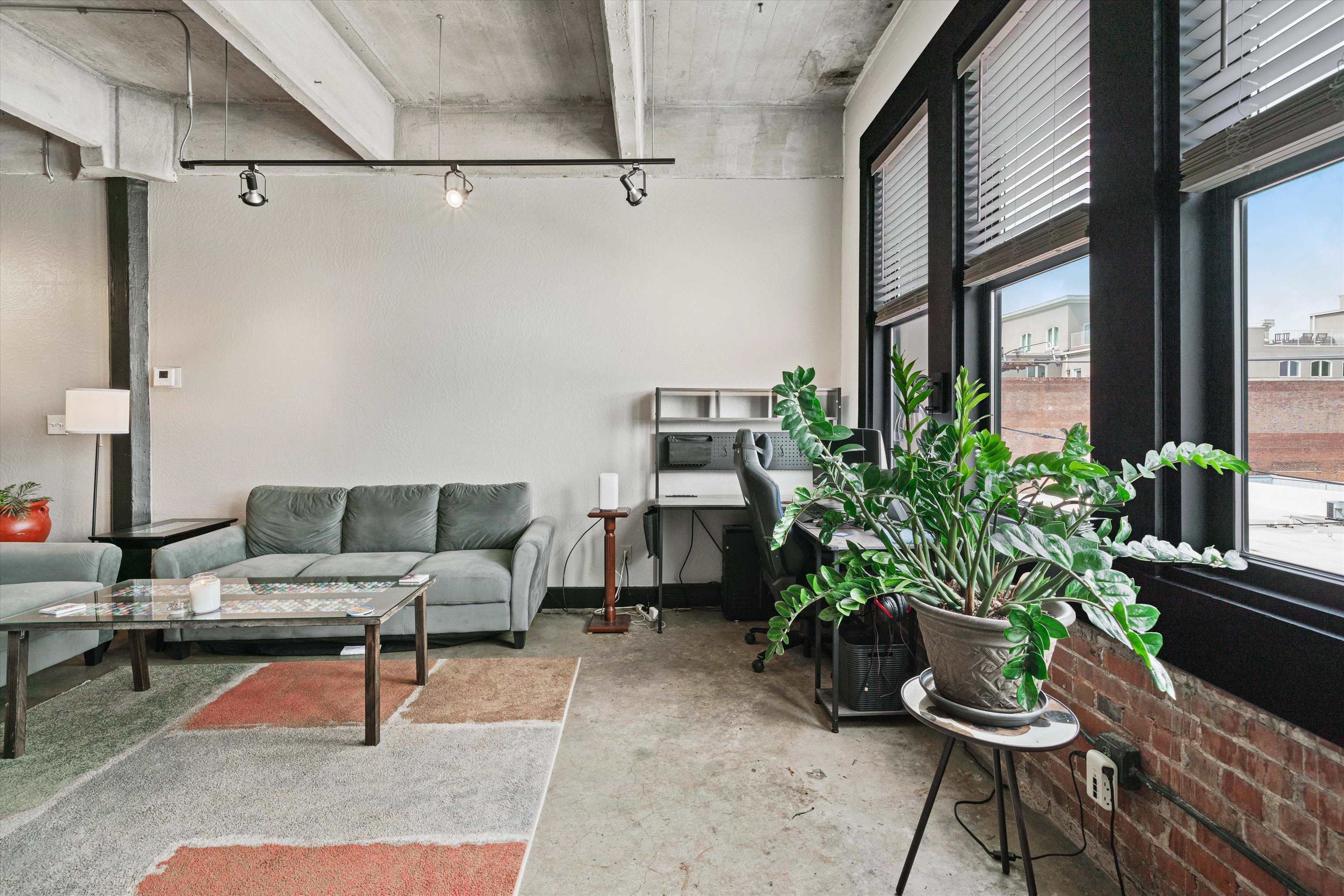 408 South Front Street, Unit 413 Memphis, TN 38103 - Photo 3 of 30 a living room with furniture and a potted plant
