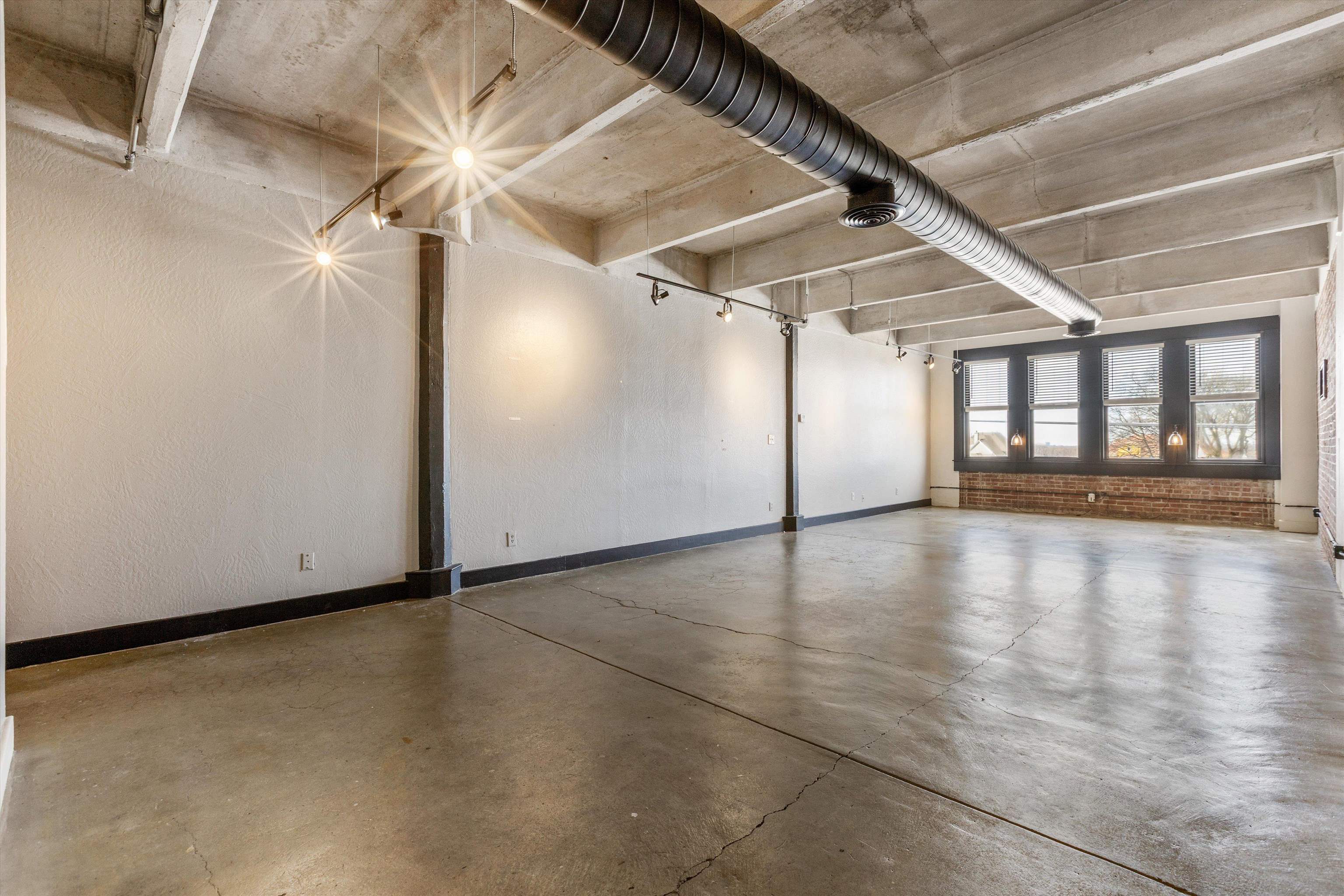 408 South Front Street, Unit 413 Memphis, TN 38103 - Photo 10 of 30 an empty room with wooden floor and windows