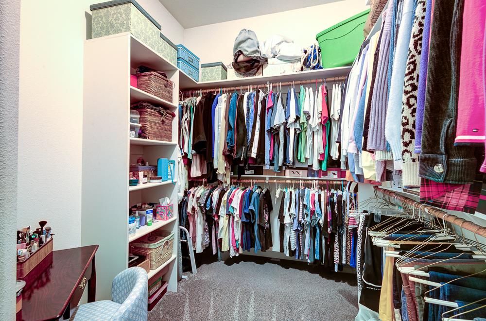 17465 Monreal Road Madera, CA 93636 - Photo 39 of 59 a view of walk in closet with clothes and shoes