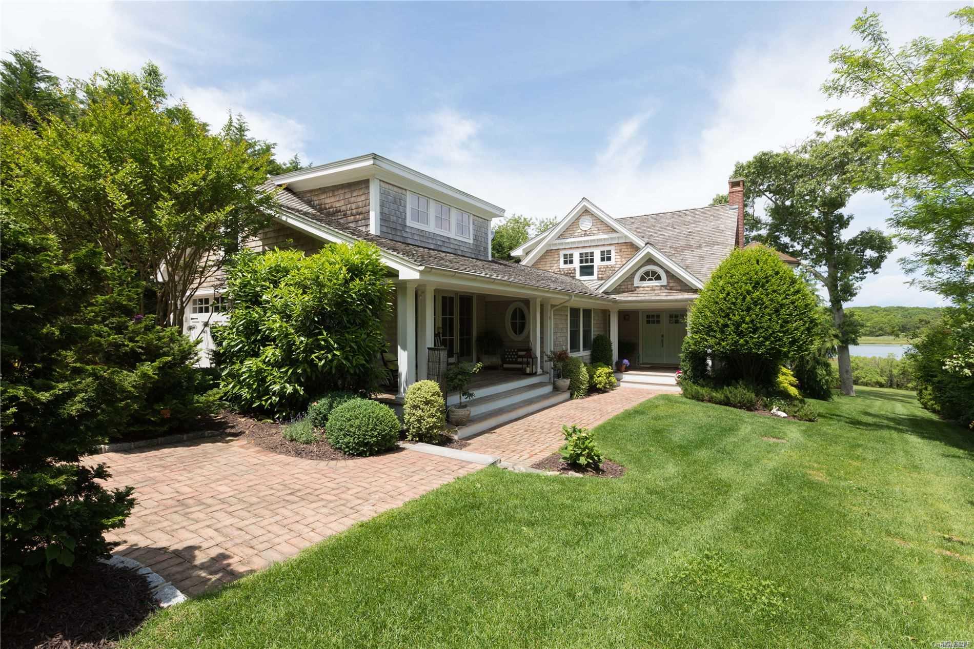 1200 Broadwaters Road Cutchogue, NY 11935 - Photo 1 of 1 a front view of a house with a yard and porch