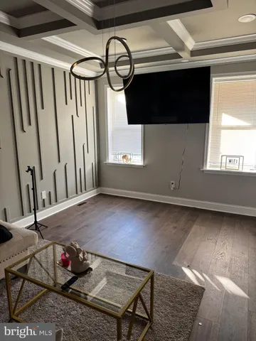 a living room with a bed furniture and a window