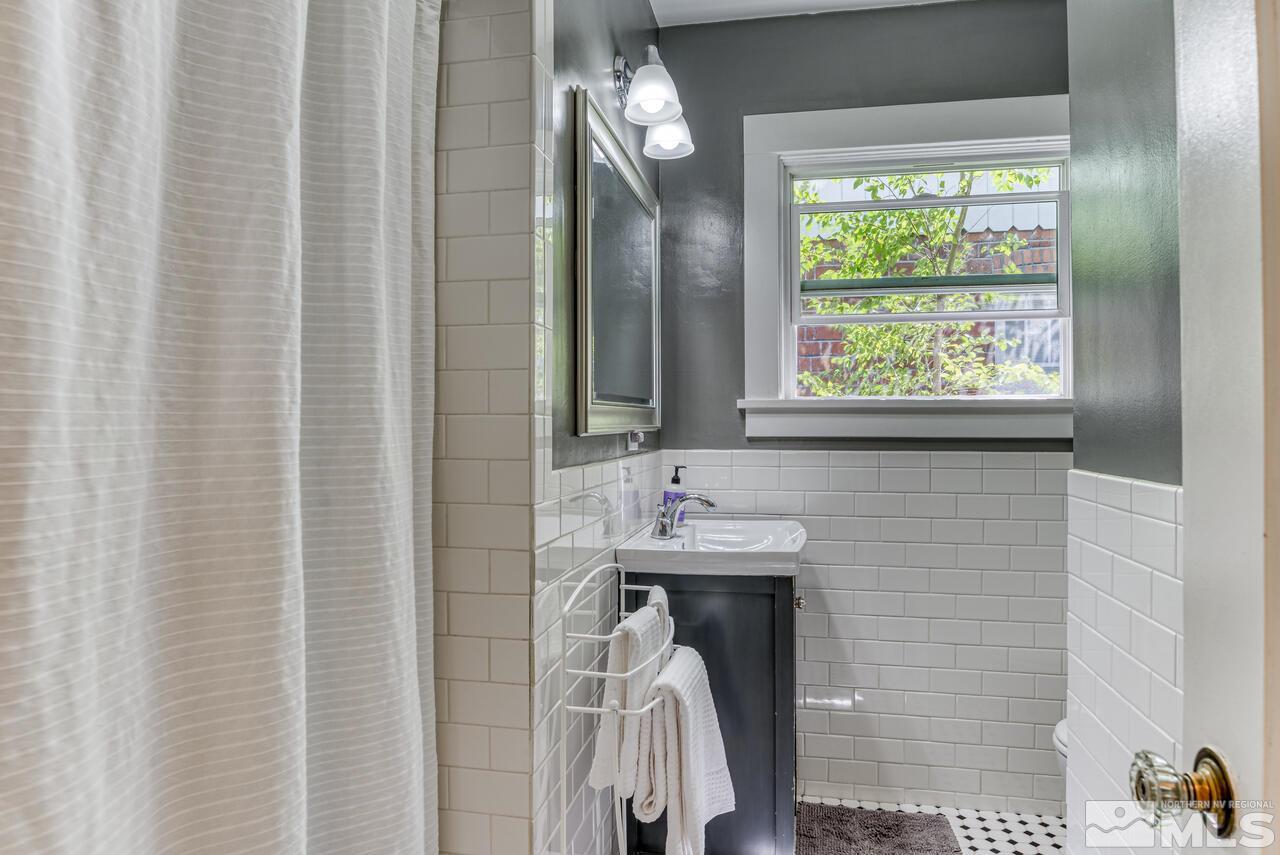 230 Martin Street Reno, NV 89509 - Photo 13 of 38 a bathroom with a sink a mirror and a shower