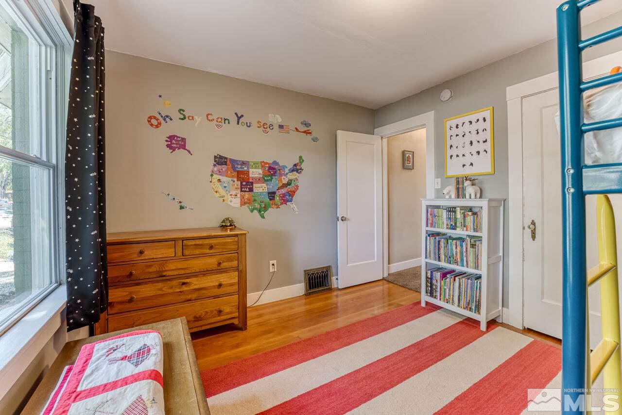 230 Martin Street Reno, NV 89509 - Photo 17 of 38 a bedroom with a bed and a book shelf