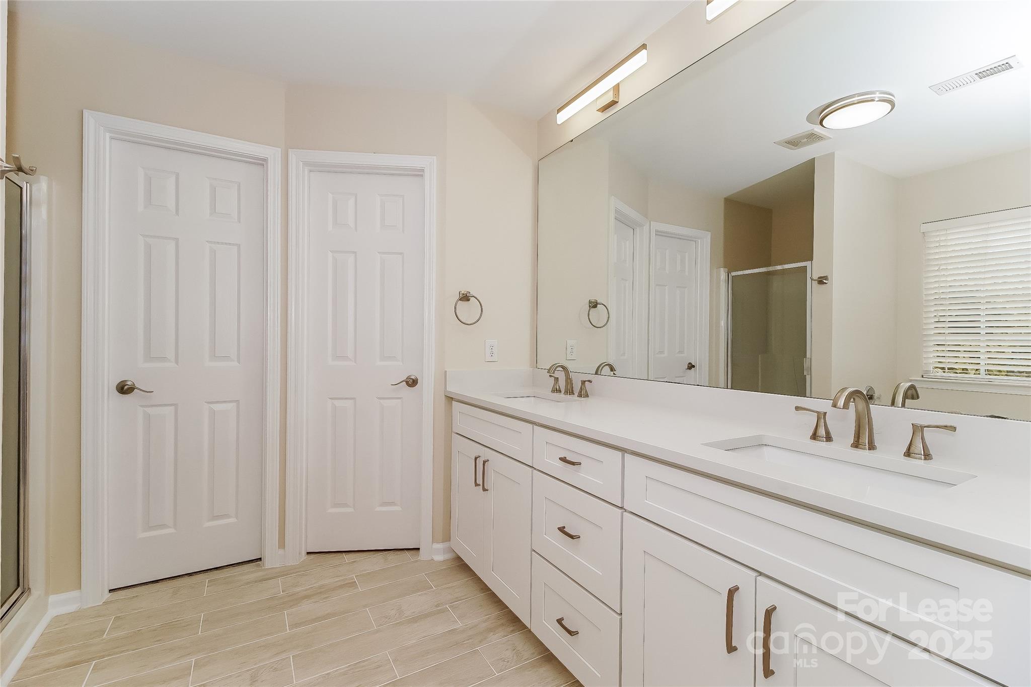 8803 Ormeau Drive Charlotte, NC 28277 - Photo 12 of 17 a bathroom with a double vanity sink and a mirror