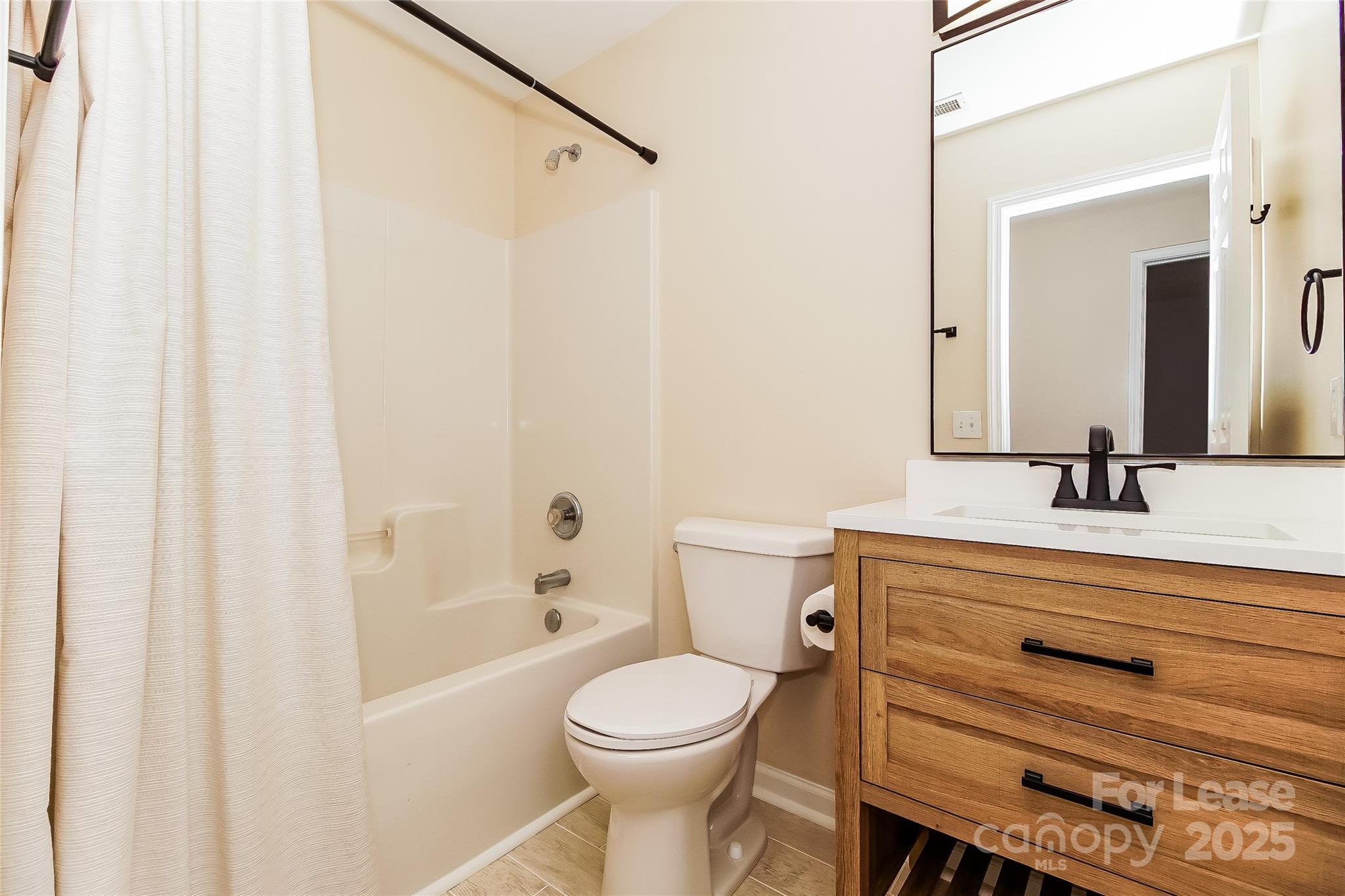 8803 Ormeau Drive Charlotte, NC 28277 - Photo 15 of 17 a bathroom with a sink a toilet and a mirror
