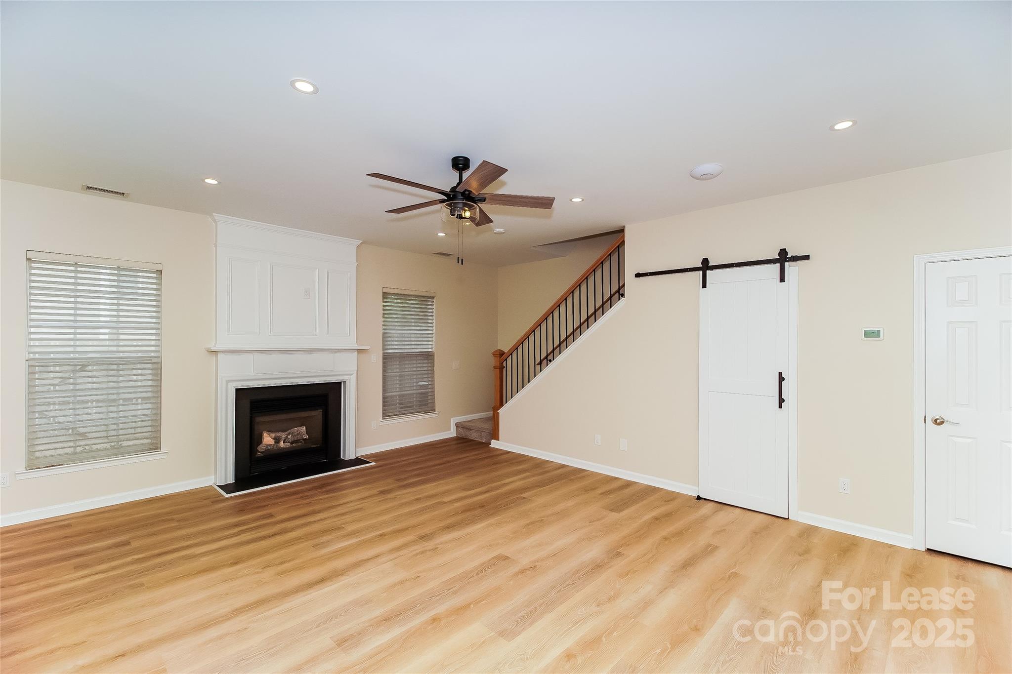 8803 Ormeau Drive Charlotte, NC 28277 - Photo 6 of 17 a view of empty room with wooden floor and fireplace