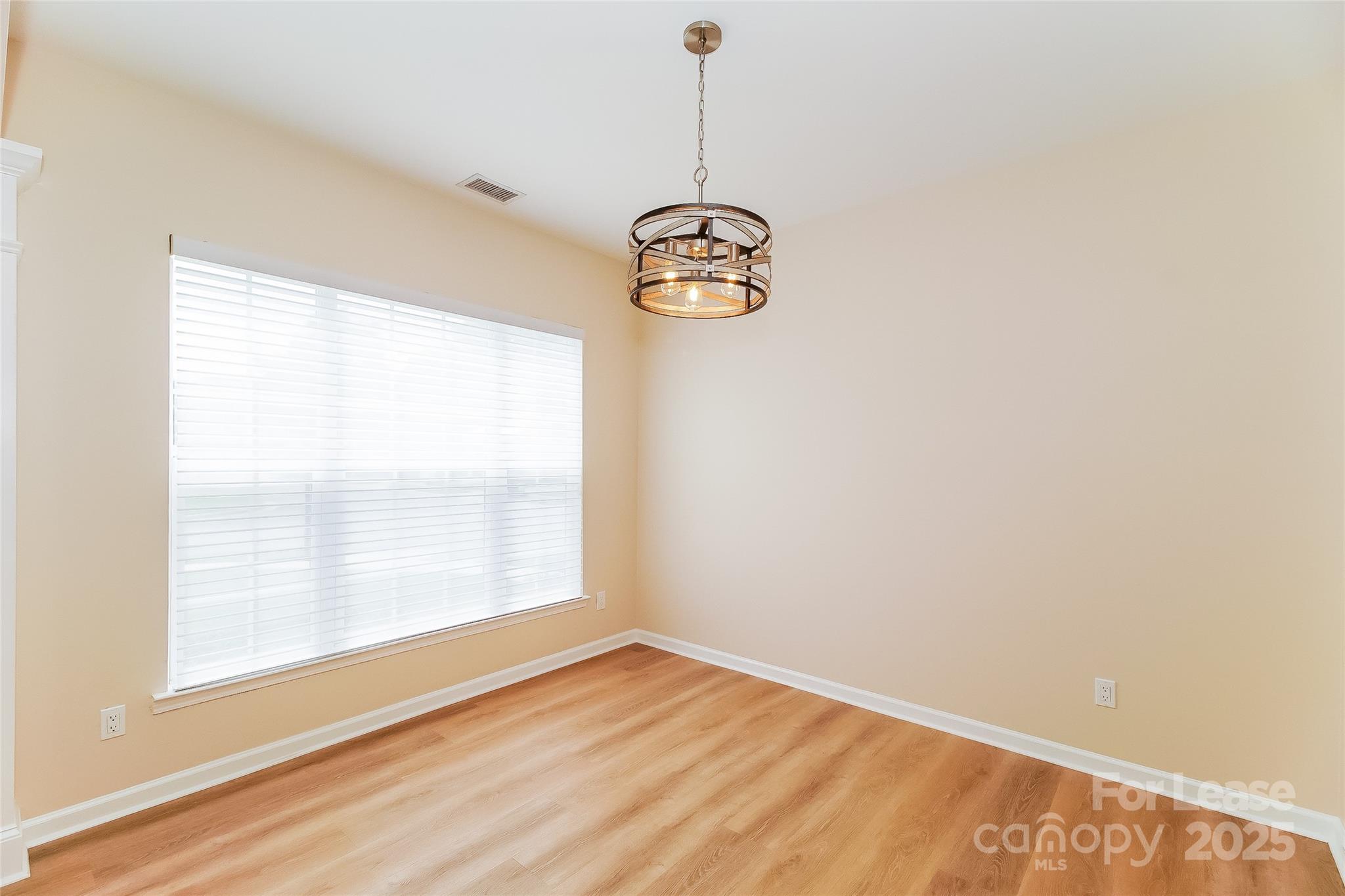 8803 Ormeau Drive Charlotte, NC 28277 - Photo 8 of 17 a view of empty room with window and wooden floor