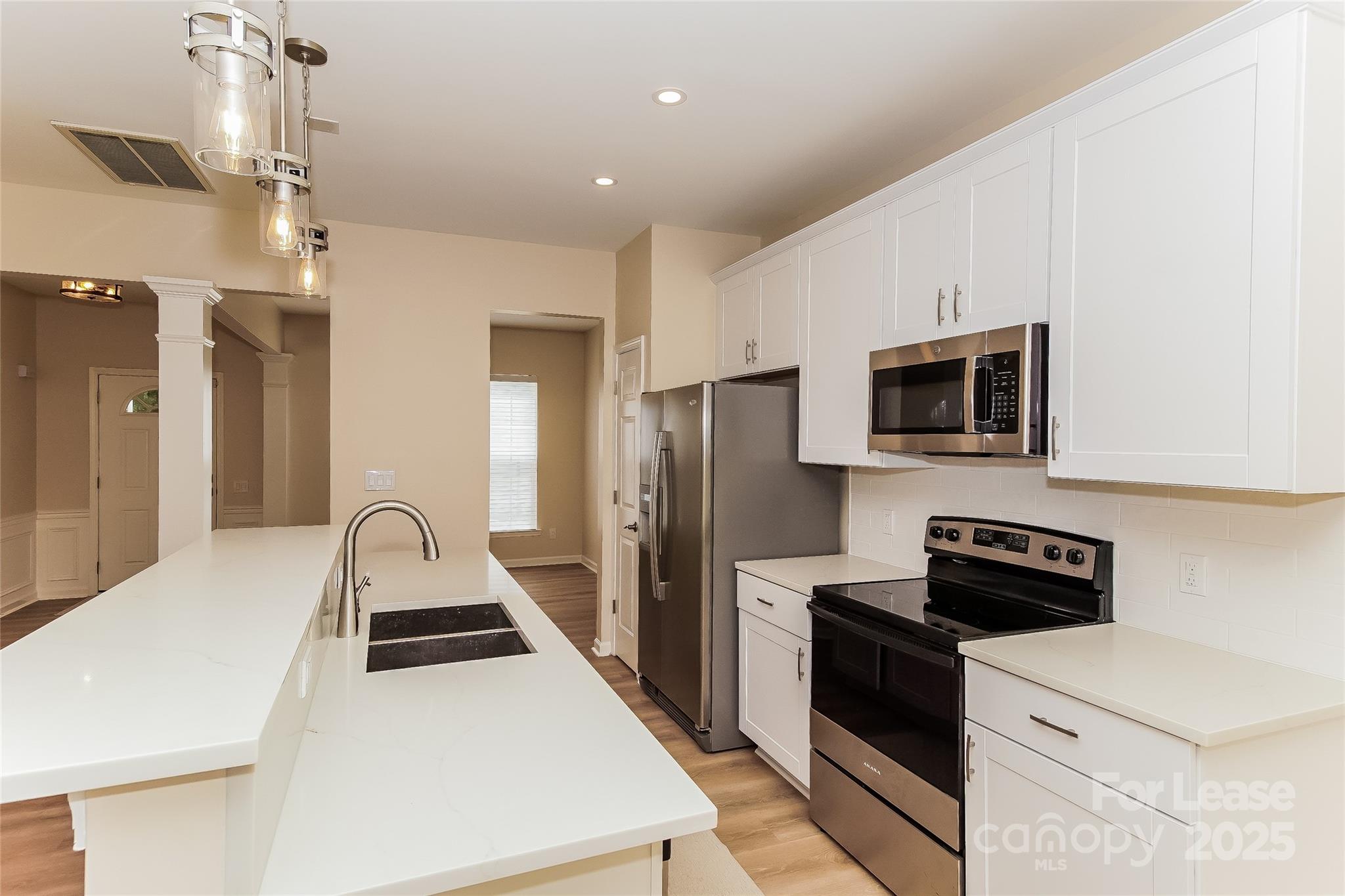 8803 Ormeau Drive Charlotte, NC 28277 - Photo 10 of 17 a kitchen that has a microwave a stove and a refrigerator