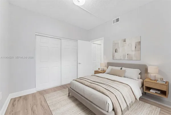 a bedroom with a bed and a lamp