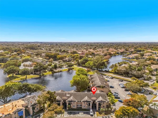 an aerial view of residential building and lake
