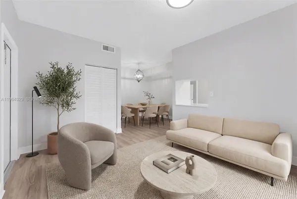 a living room with furniture and a potted plant
