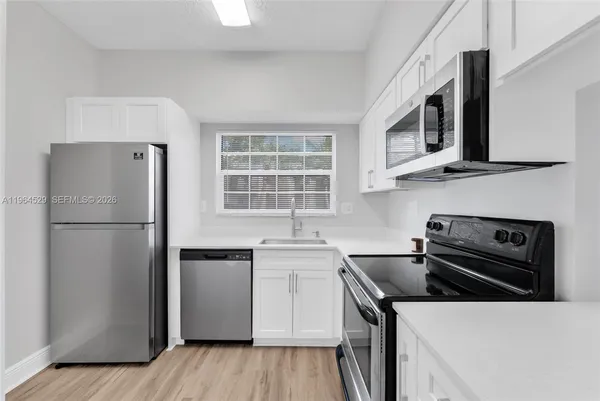 a kitchen with a refrigerator stove and sink