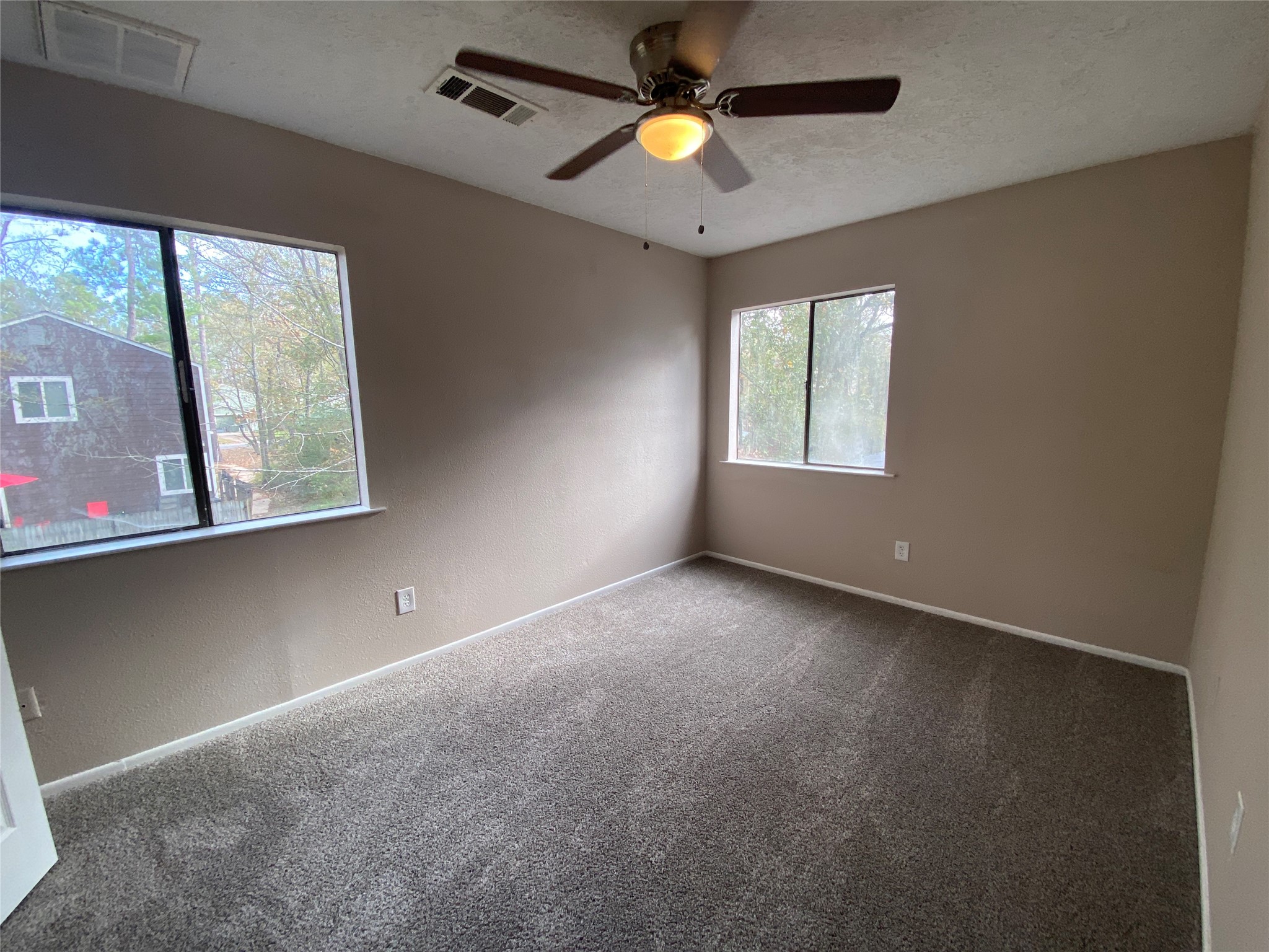 26620 Orchid Court Point Blank, TX 77364 - Photo 14 of 21 an empty room with windows and fan