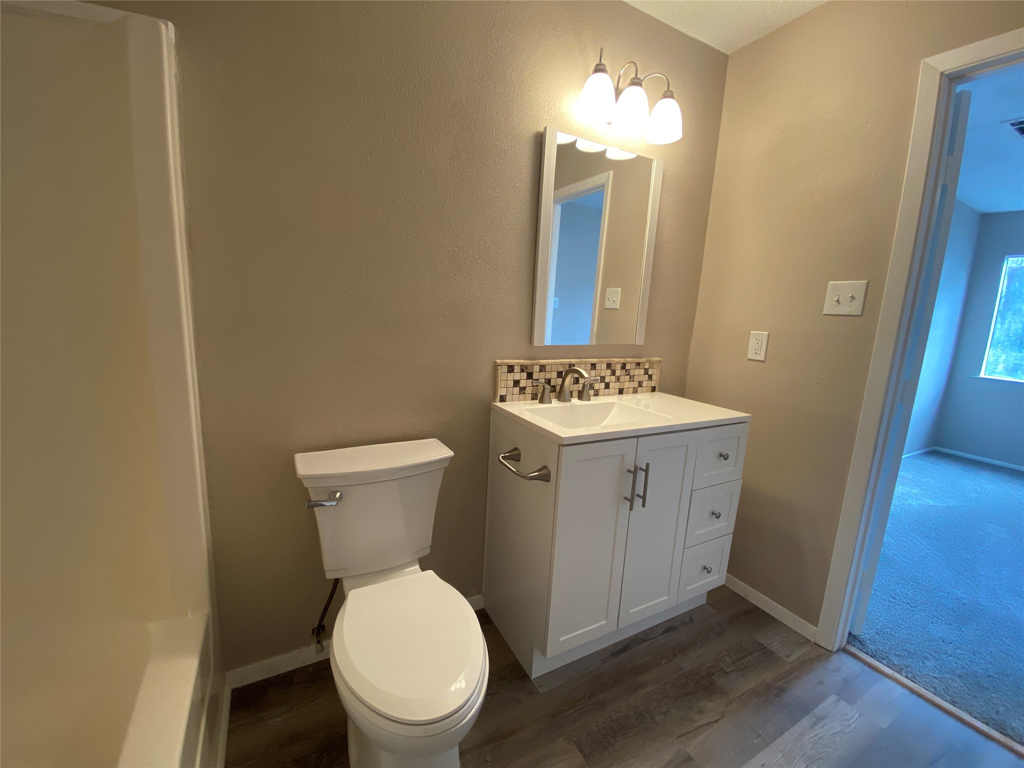 26620 Orchid Court Point Blank, TX 77364 - Photo 17 of 21 a bathroom with a toilet a sink and a mirror