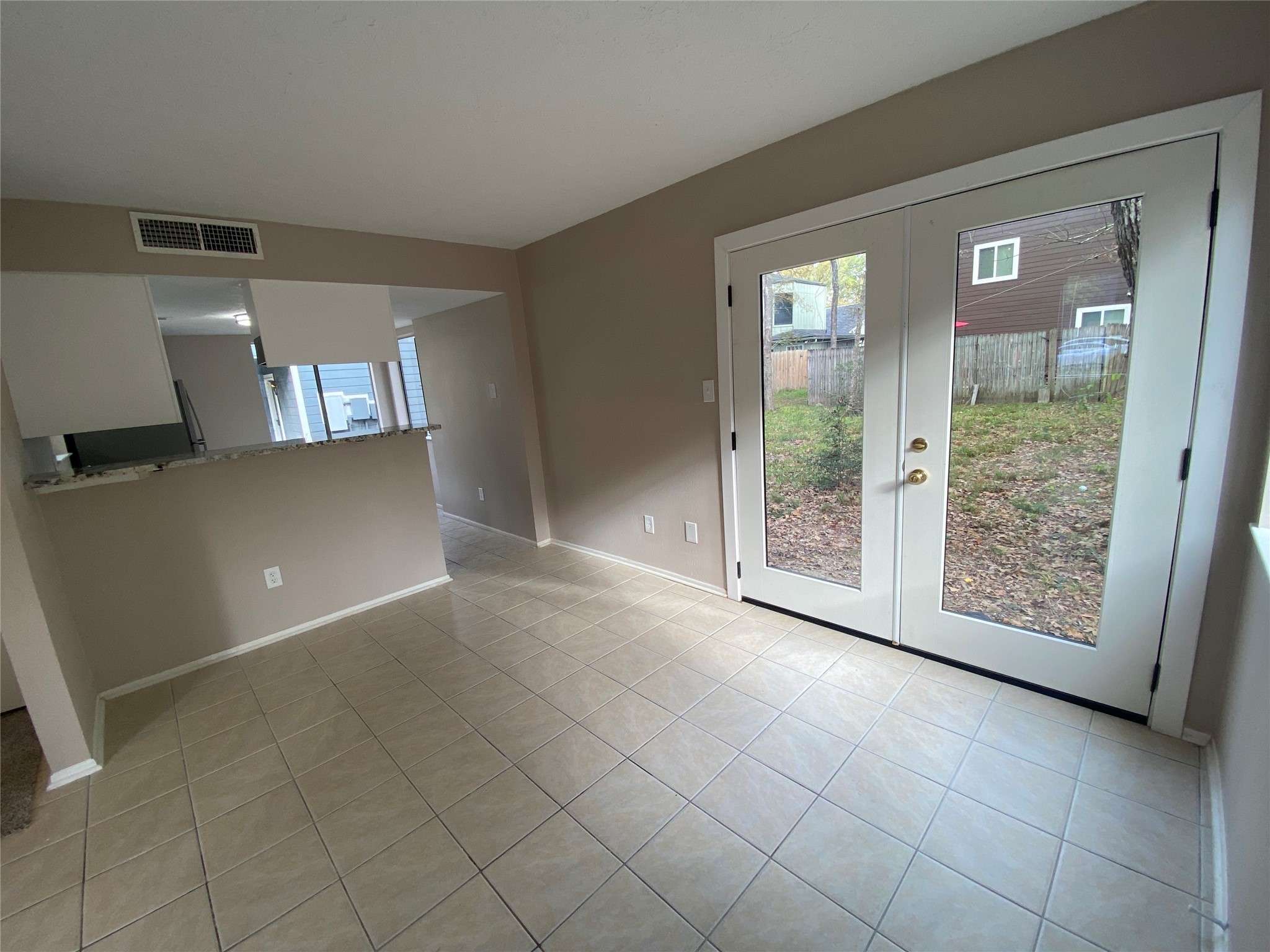 26620 Orchid Court Point Blank, TX 77364 - Photo 6 of 21 What an open feel with the French doors and vaulted ceiling! Notice the living area is open to the kitchen, so no worries about the cook being left out.