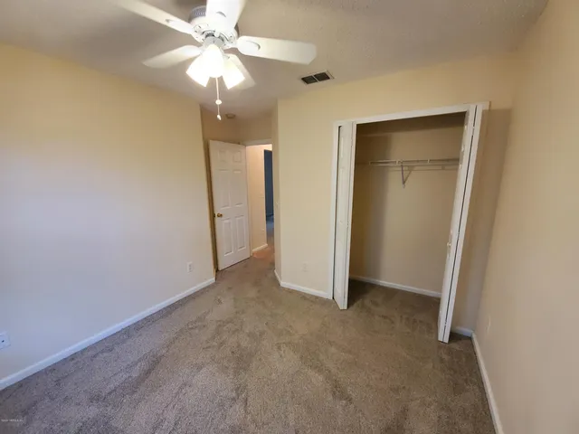 a view of a livingroom with a ceiling fan and window