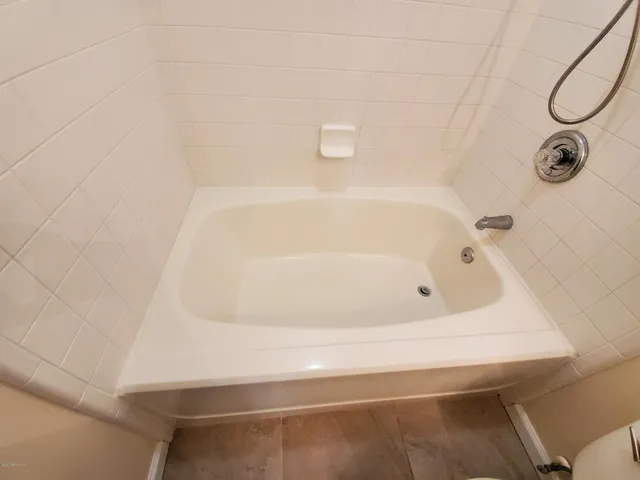 a bathroom with a sink toilet and mirror