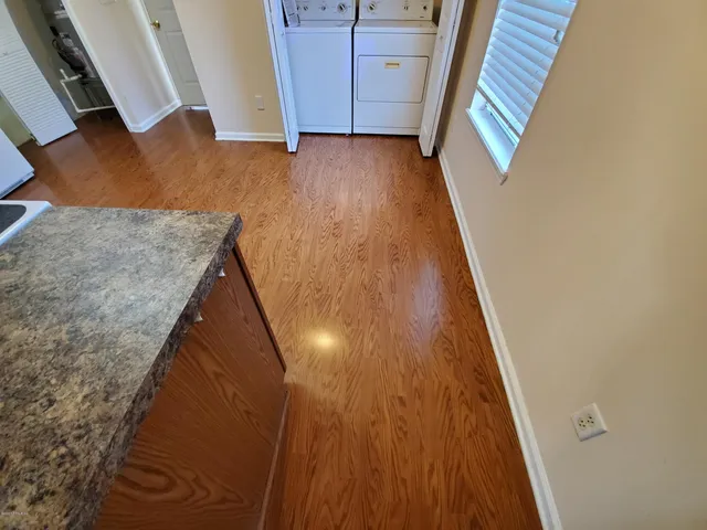 a view of a kitchen with fridge and workspace