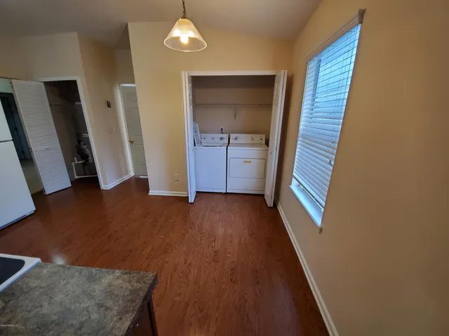 a kitchen with granite countertop wooden floors and stainless steel appliances